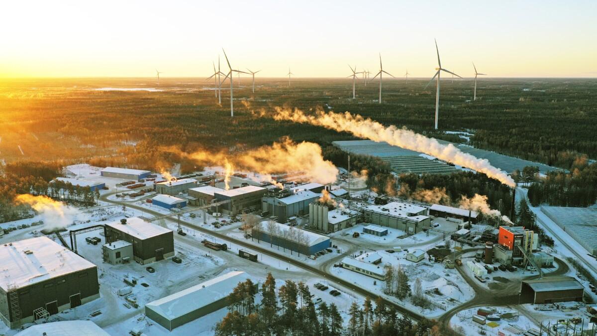 Aerial photo from Kirkkokallio Eco-Innovation Park with production plants and wind mills.